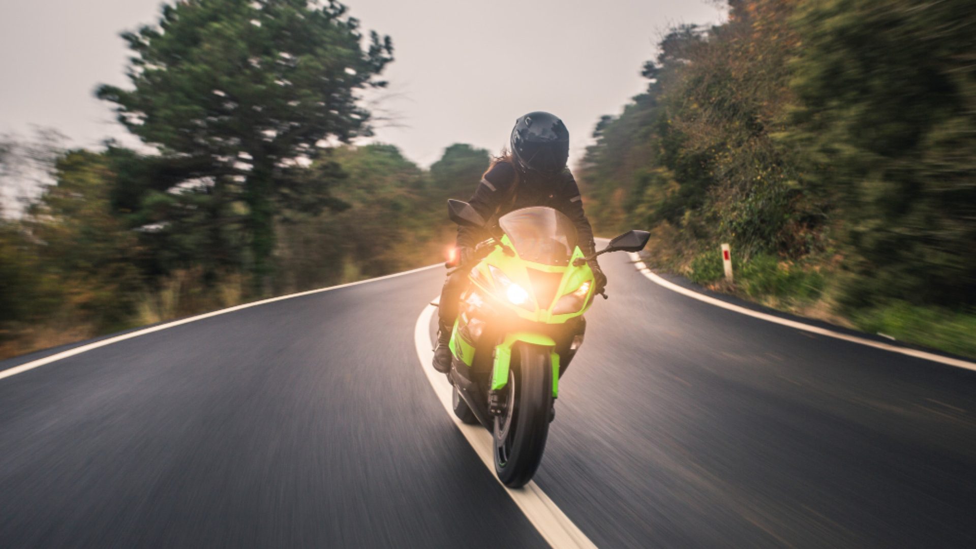 driving-green-neon-color-motorcycle-road-front-view (1)