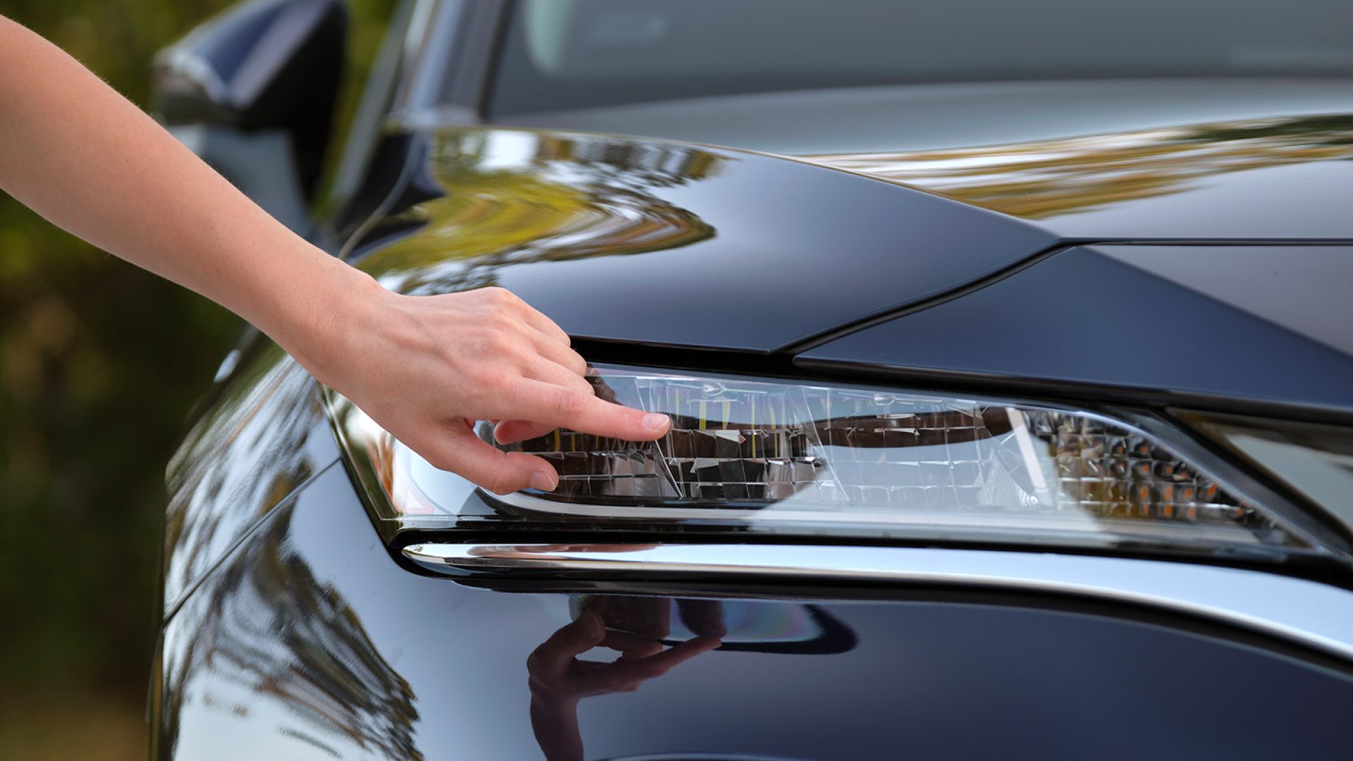 female-driver-hands-checking-headlight-her-new-car-purchase-vehicle-concept