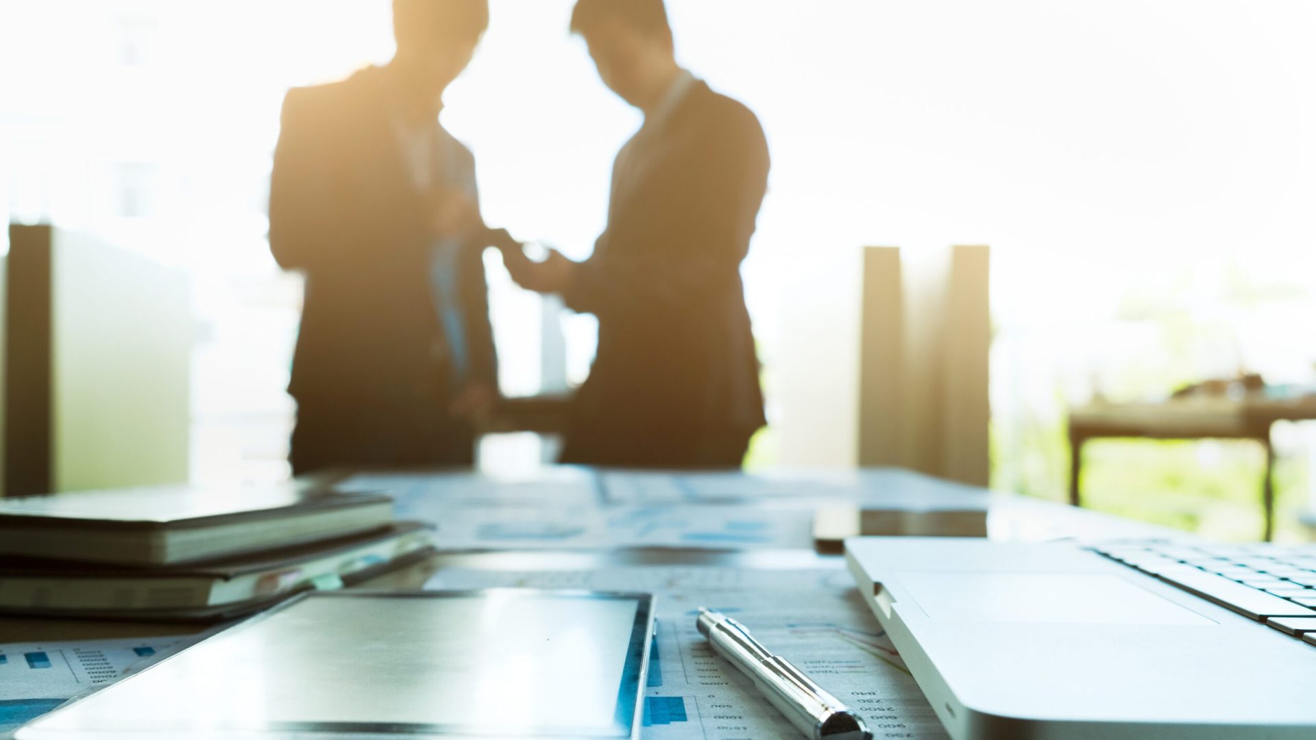 Image of business  workplace with team partners interacting on background