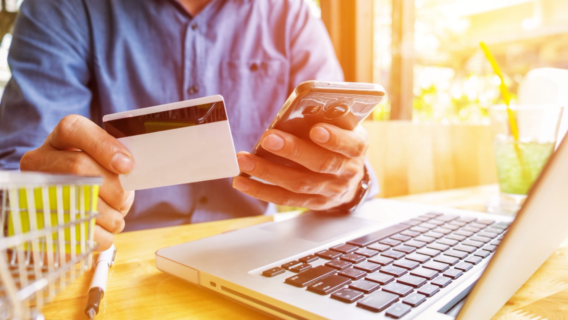 man-holding-credit-card-hand-entering-security-code-using-laptop-keyboard