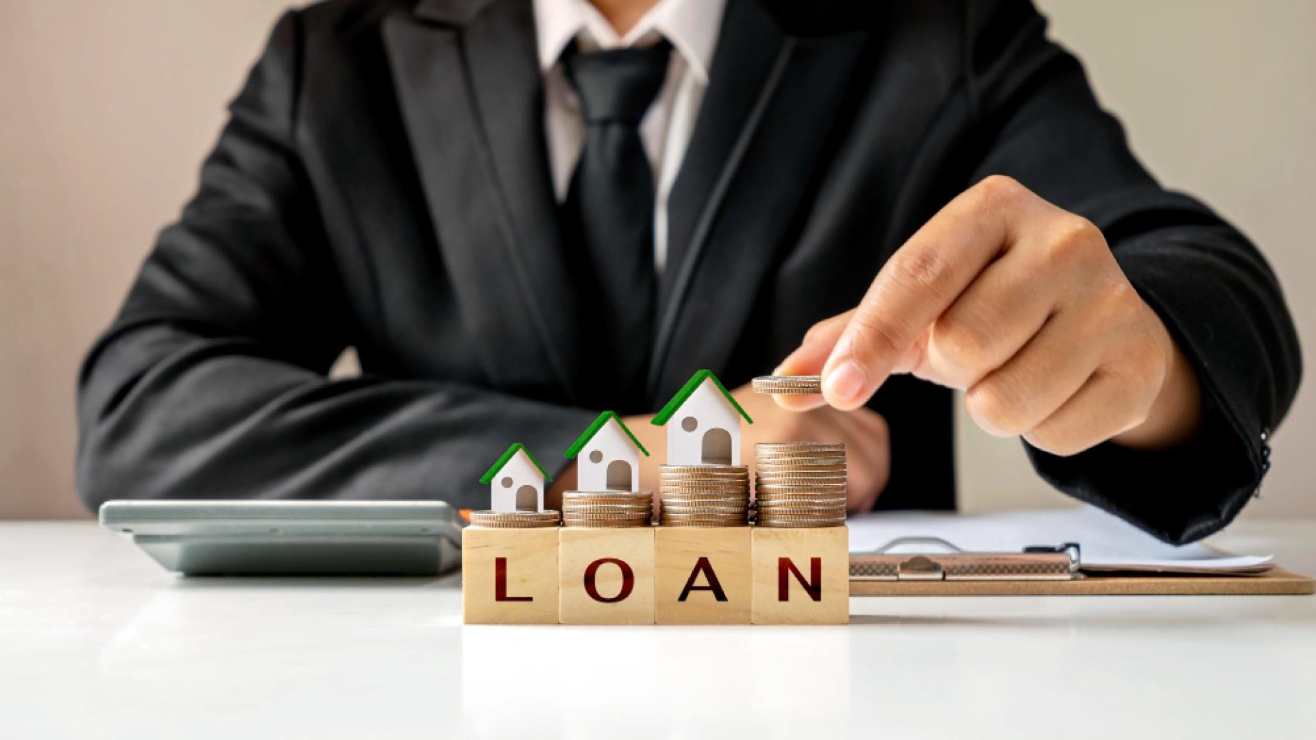 model-house-pile-coins-businessman-holding-coins-real-estate-investment-ideas-home-loans-new-home-loans-lowinterest-rates-homes