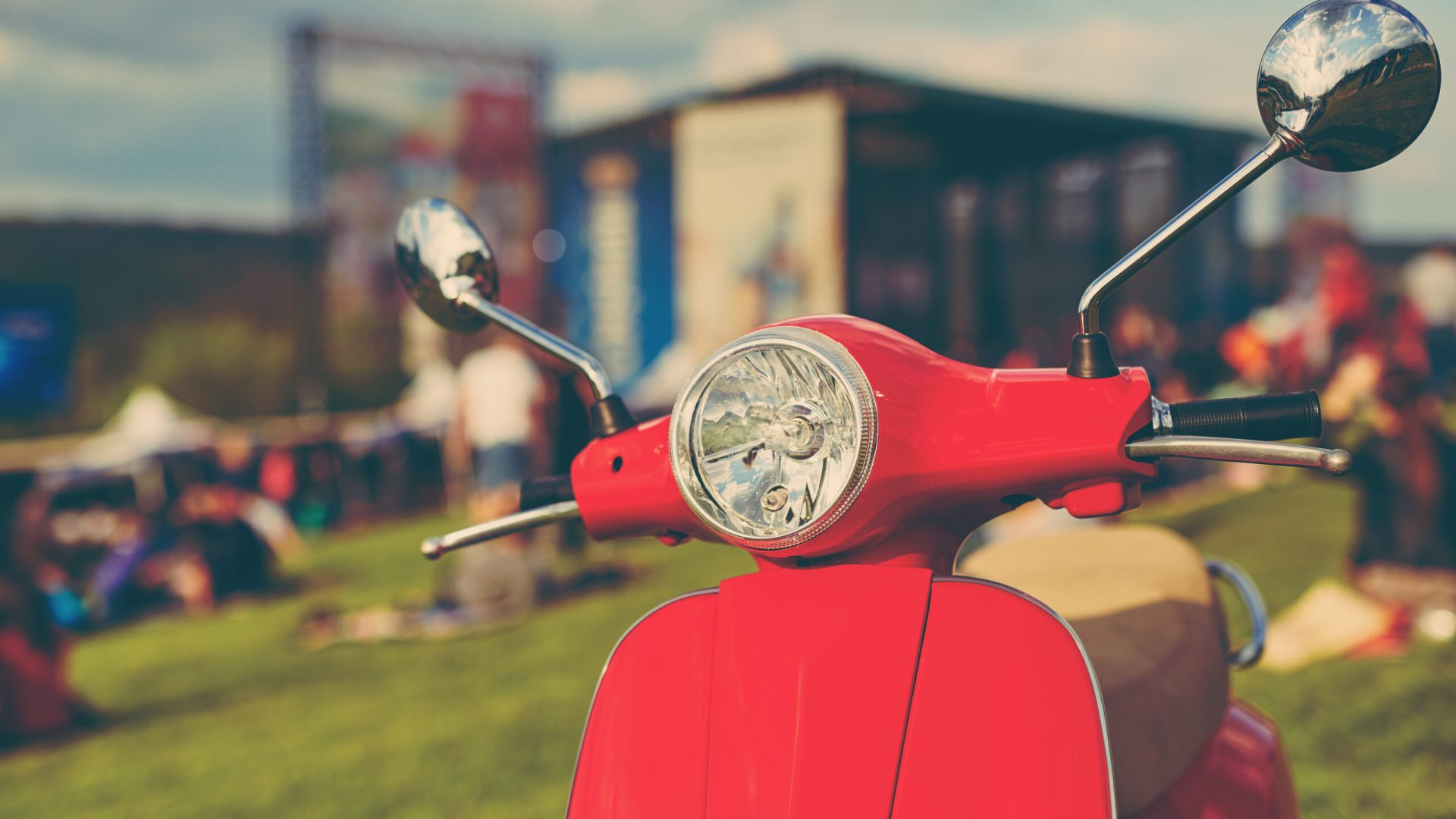 Red retro scooter on grass. Effect retro film