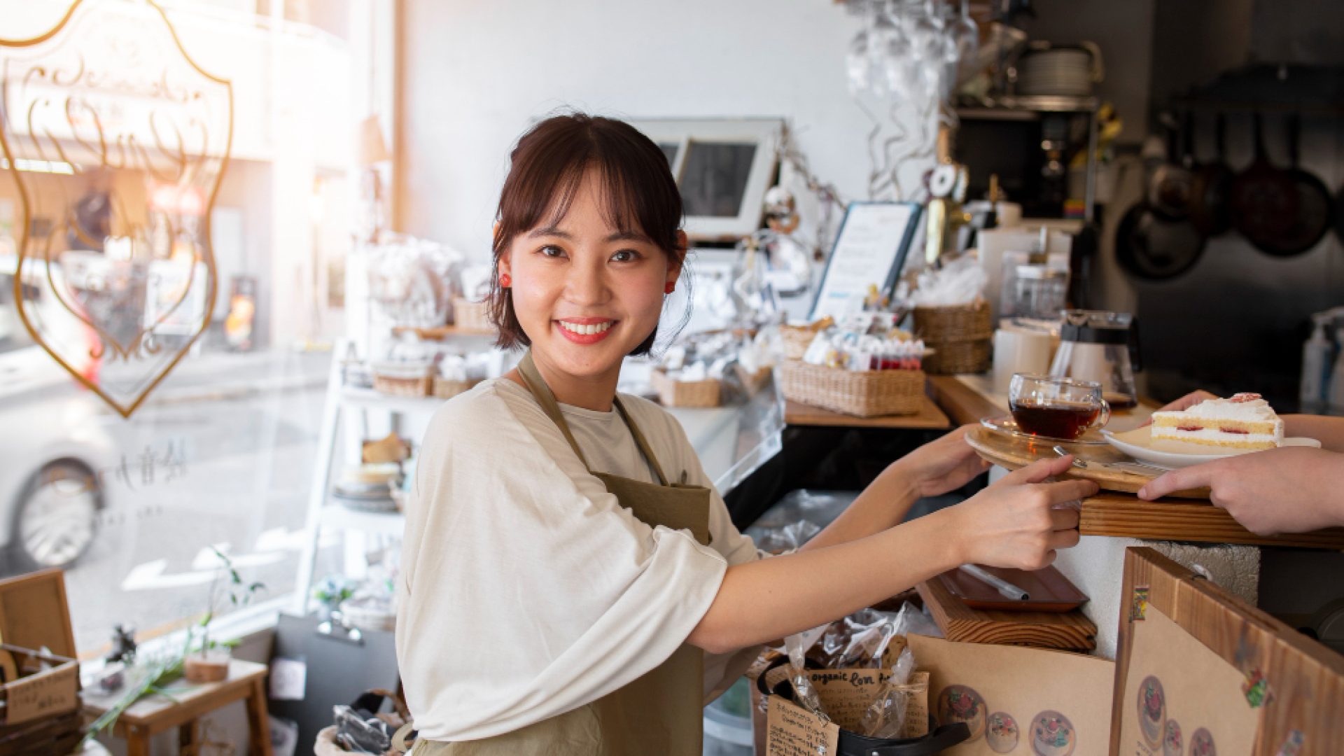 young-woman-arranging-her-cake-shop